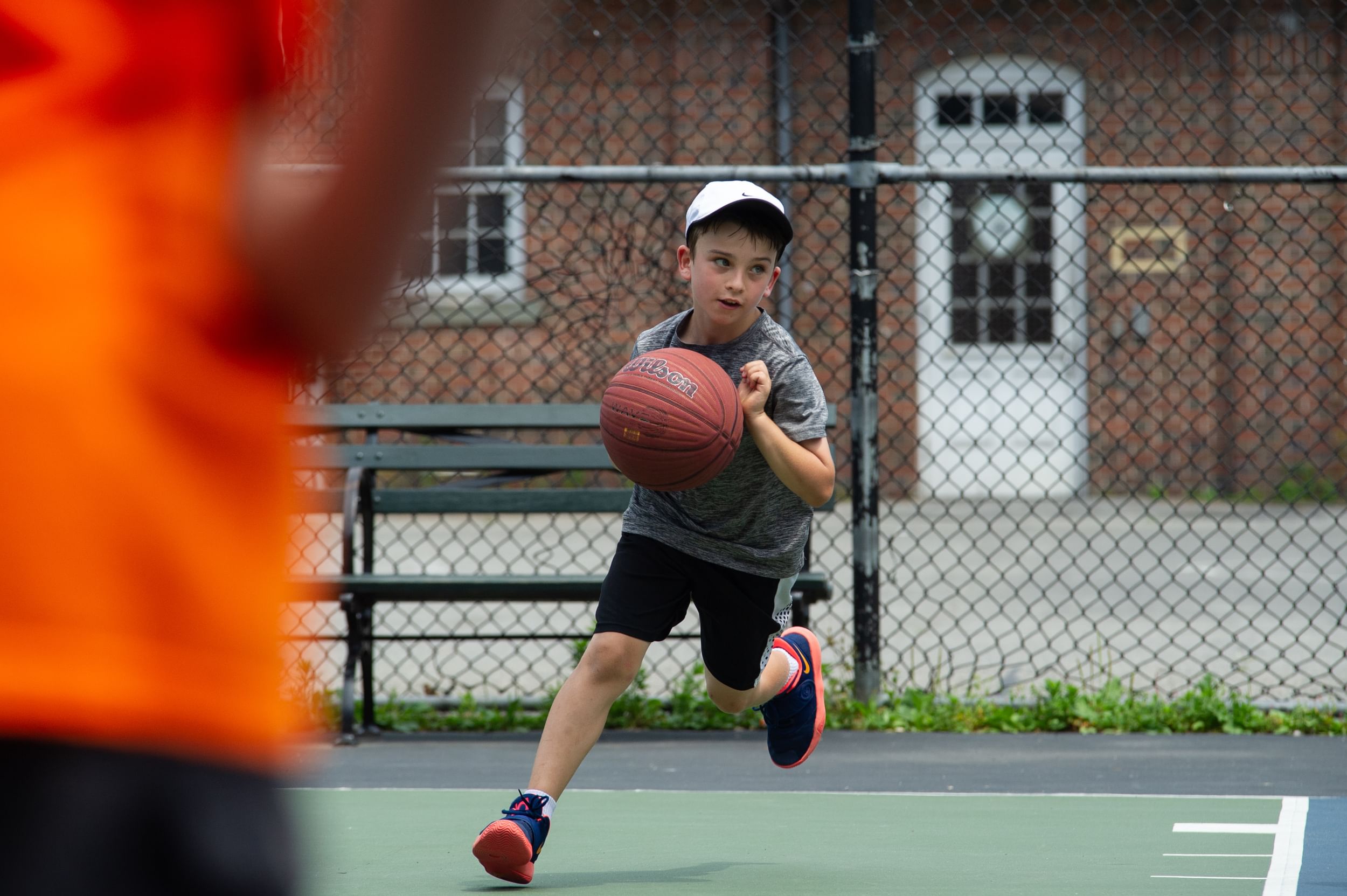 A young baller caught in mid-dribble