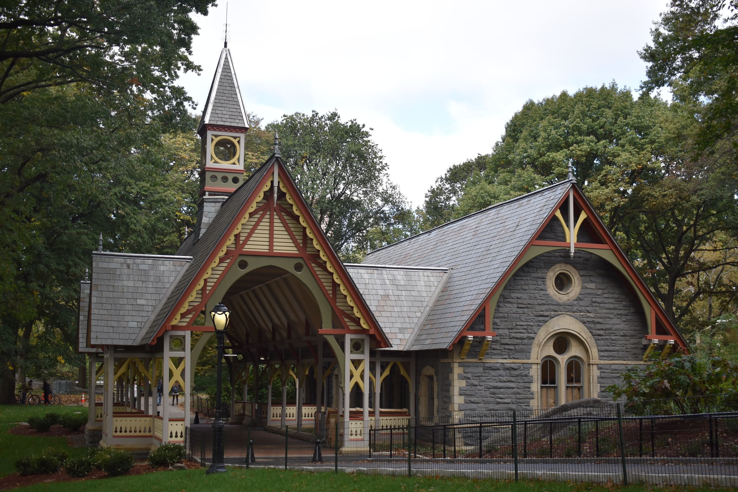 The Dairy Visitor Center & Gift Shop, a Victorian-style building nestled among the trees of Central Park.