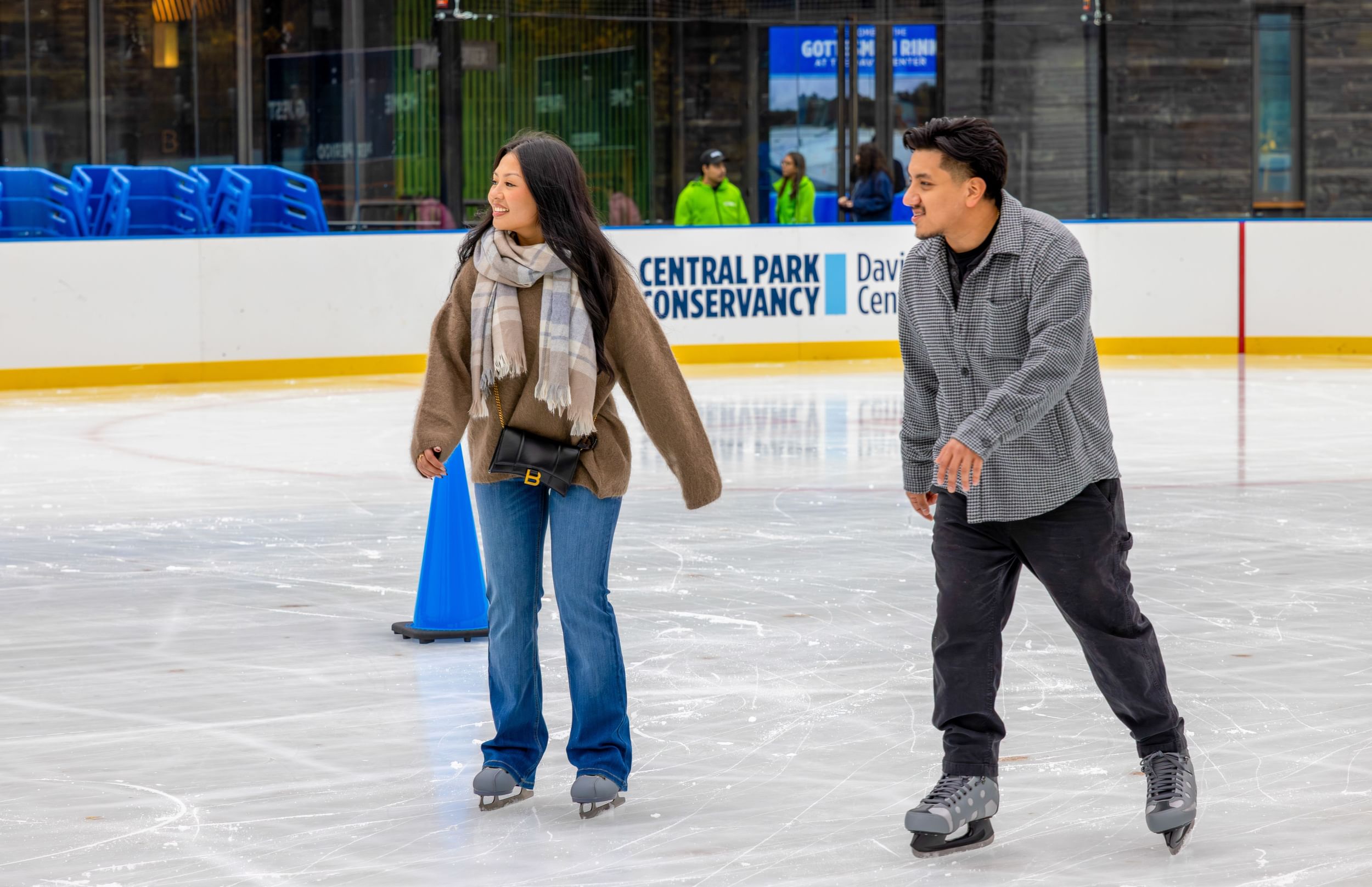 A couple skating together on the Gottesman Ice Rink at the Davis Center in Harlem, NYC