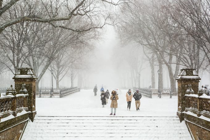 A view looking down the Mall from the steps of Bethesda Terrace on a snowy winter day
