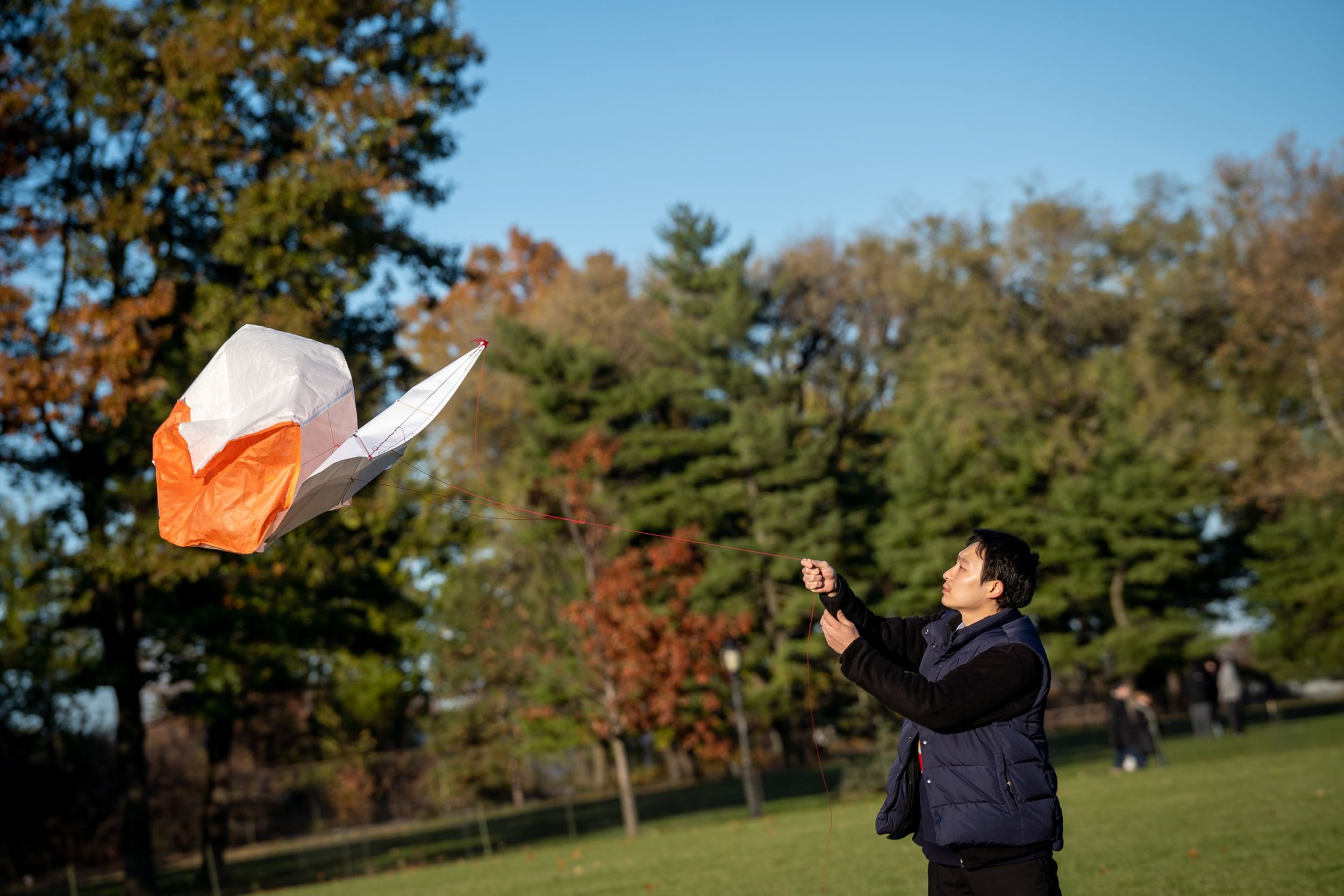 A visitor cajoles his kite into the wind on an autumnal day in the Park